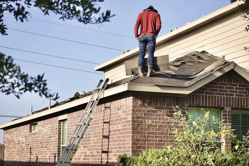 Professional roofer working on a residential roof in Rush Valley